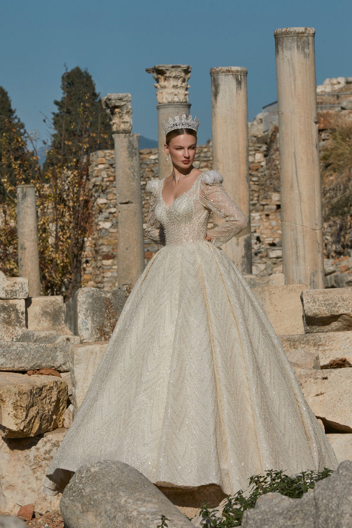 Gilded Dreams: Cream Wedding Dress with Shimmering Gold Accents