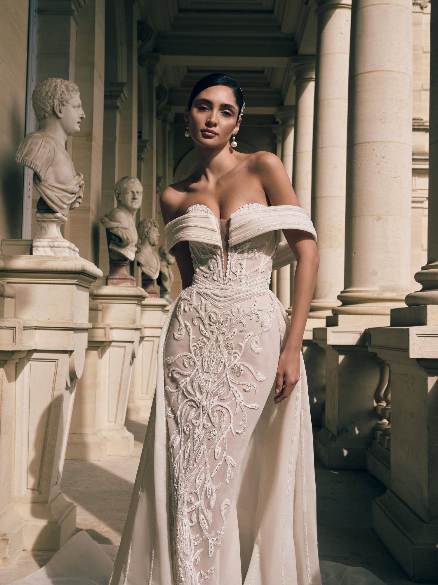Off-the-shoulder mermaid wedding dress with bead and crystal embroidery on nude tulle and detachable overskirt – Imperia bridal collection
